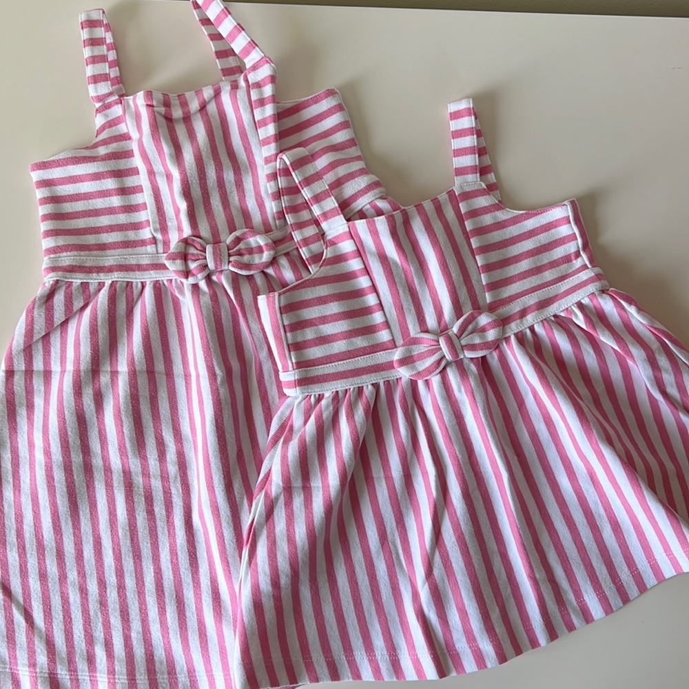 White and pink striped dress with bow detail at waist.